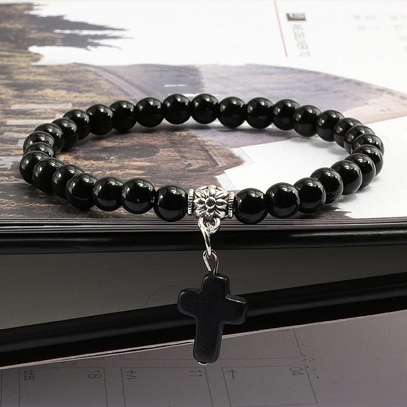 Prayer bracelet with black natural stone beads and a Jesus cross pendant, perfect for religious and everyday wear.