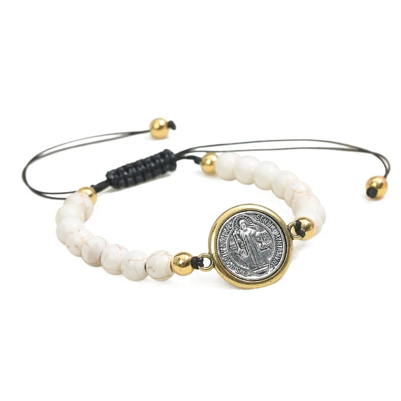 Elegant adjustable white color bracelet featuring turquoise beads and a gold-toned Saint Benedict medal on a durable black cord.