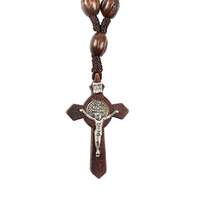 Traditional wooden decade rosary with dark wooden beads and a classic wooden crucifix.