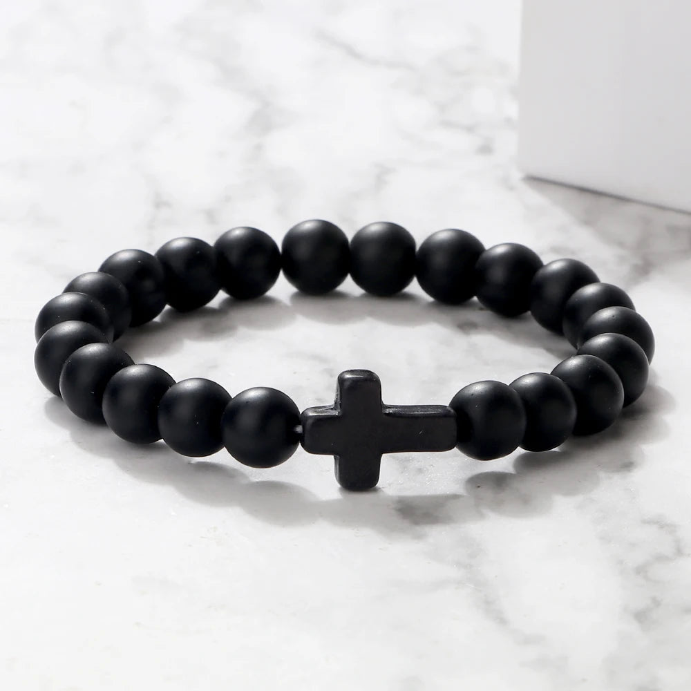 Handcrafted black matte beaded bracelet with natural stone beads and a cross charm, perfect for prayer on the go or daily wear.