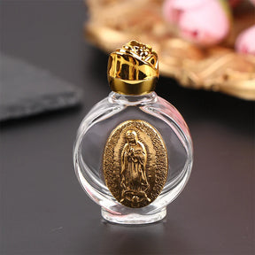 Glass holy water bottle with a gold Our Lady of Guadalupe medallion and a rose-shaped twist-on lid. Use for: Baptism, First Communion, Holy Communion, Confirmation, Blessing of Homes, Blessing of Objects, Personal Devotion, Sacramentals, Church Entrances, Funerals, Easter Vigil, Special Feast Days, Easter, Weddings, Christmas.