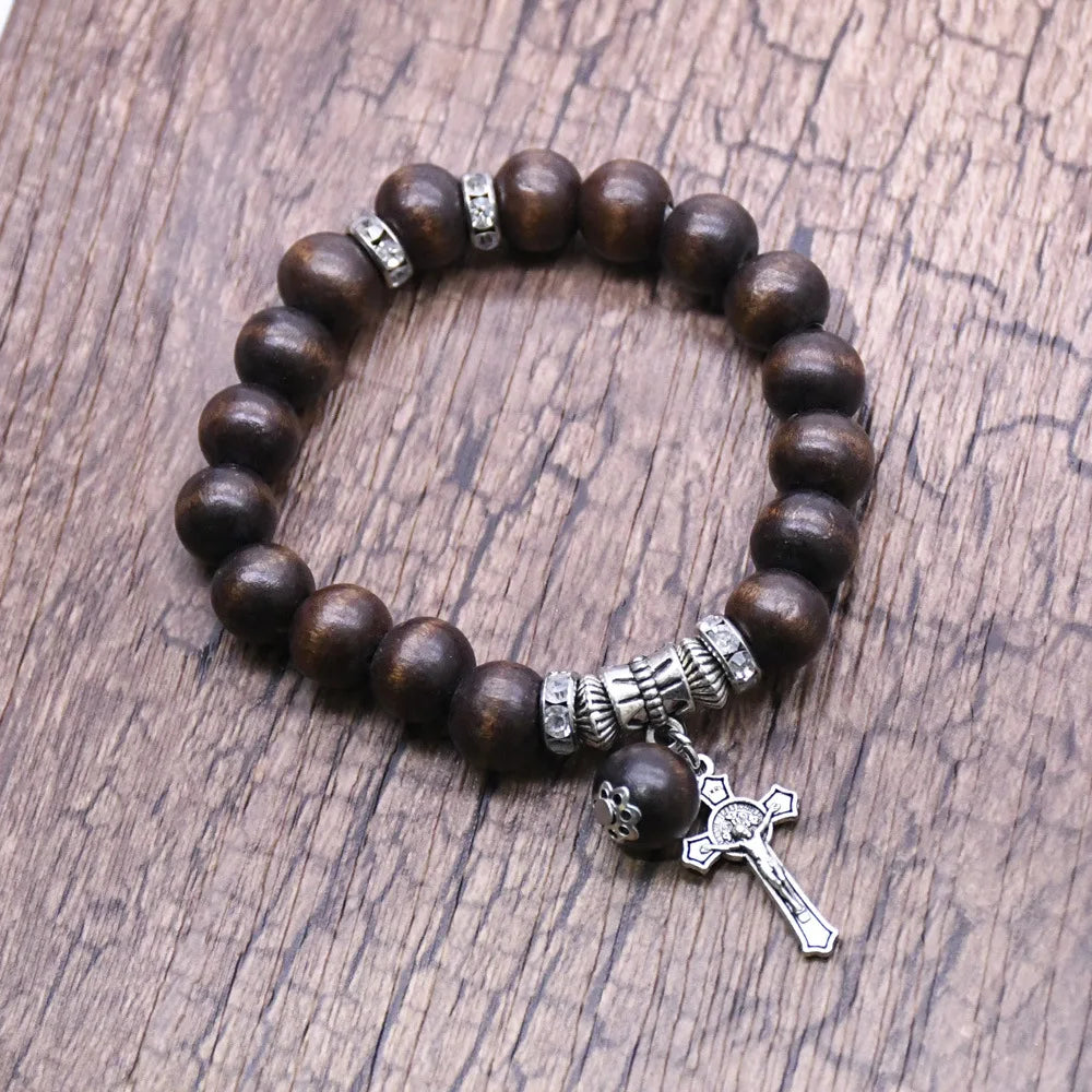 Elegant bracelet featuring rich coffee-colored wooden beads, silver-tone accents, and a detailed Jesus cross pendant.