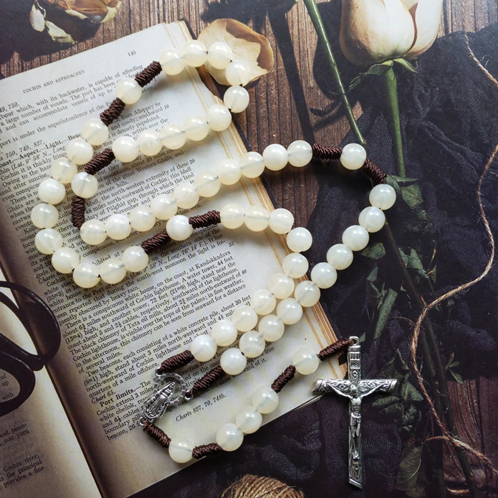 This beautifully crafted acrylic beige bead rosary, featuring a detailed Virgin Mary medal and elegant crucifix pendant.