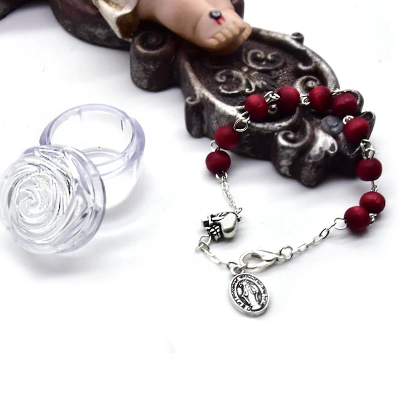 Vintage-style bracelet featuring dark red scented wooden beads and a silver St. Mary pendant on a chain, perfect for spiritual expression and fashion.