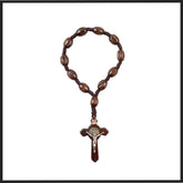 Traditional wooden decade rosary with dark wooden beads and a classic wooden crucifix.