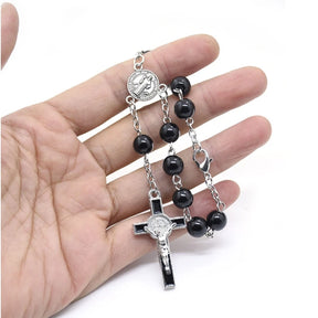 Black glass decade rosary bracelet featuring 8mm beads and a silver crucifix pendant